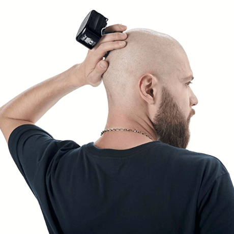 man using razor to shave head