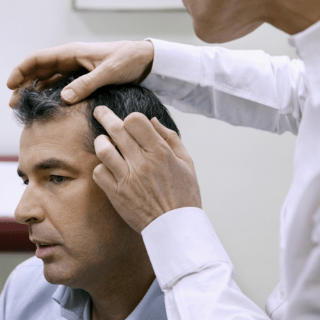Man being examined at hair loss clinic- new news for the best hair loss treatment
