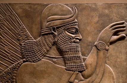 Ancient relief of an assyrian god.