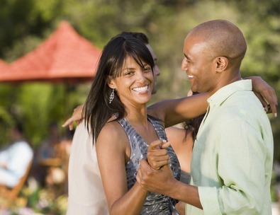 African American couple dancing outdoors