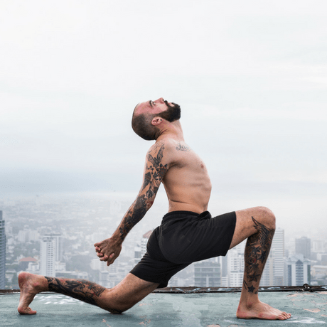 yoga for hair loss- does it work? man with thin hair yoga on top of building