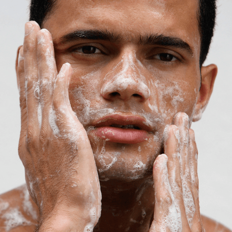 man cleansing his face for fresh skin